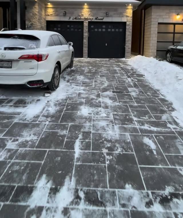 Paver driveway cleared of snow with salt spread on it
